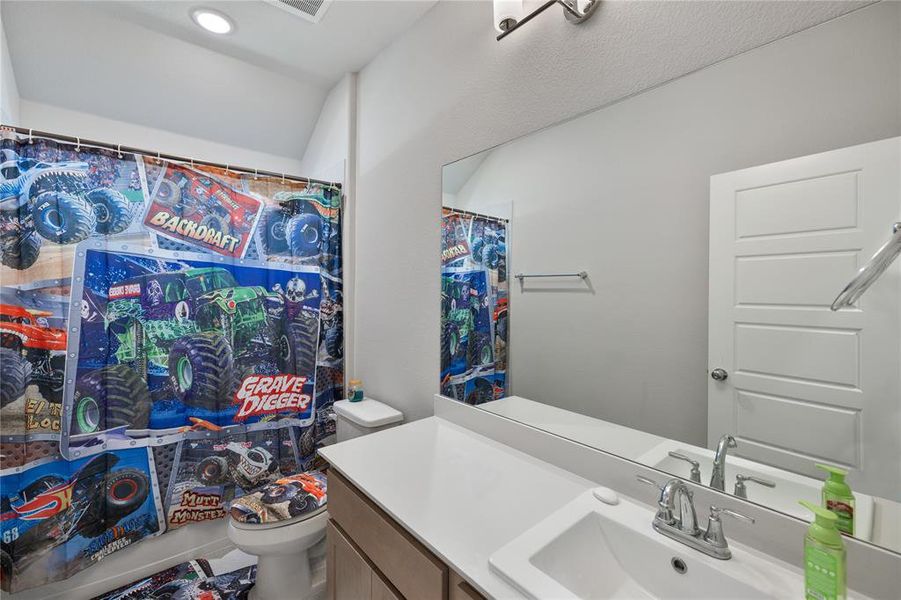 Bathroom featuring vanity and toilet