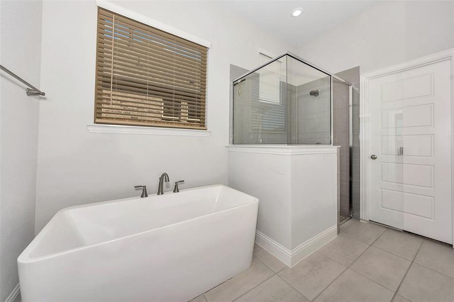 Bathroom featuring tile patterned floors and separate shower and tub