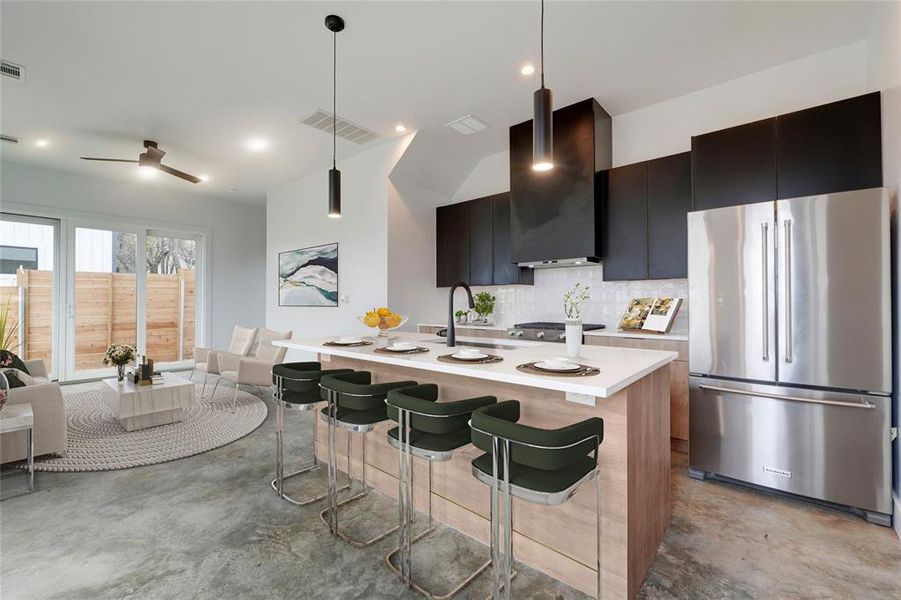 Eat in kitchen featuring large island. Virtually staged photo.