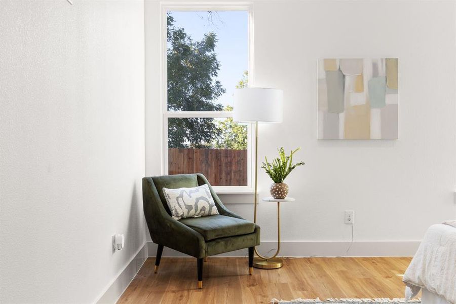 Sitting room with hardwood / wood-style flooring and a healthy amount of sunlight