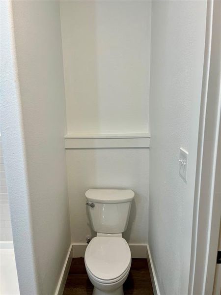 Bathroom featuring toilet and Vinyl plank flooring