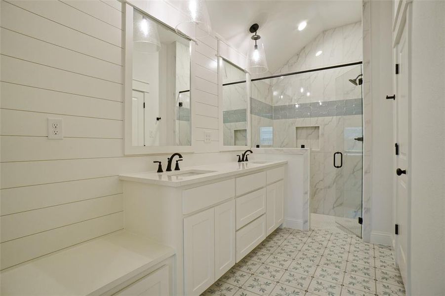 Bathroom featuring walk in shower, tile patterned flooring, double sink vanity, and vaulted ceiling