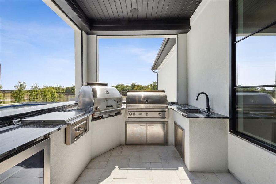 View of patio / terrace featuring sink, exterior kitchen, and area for grilling