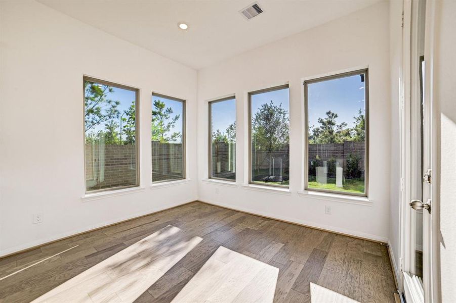 Breakfast area attached to the kitchen surrounded by exquisite windows gives view to your private backyard.