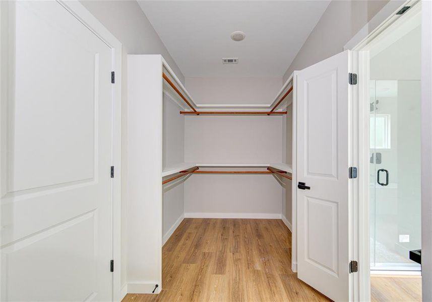 Large walk-in closet with access to laundry room