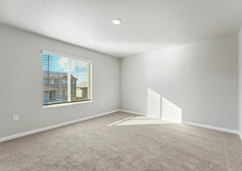 The master bedroom has a large window.