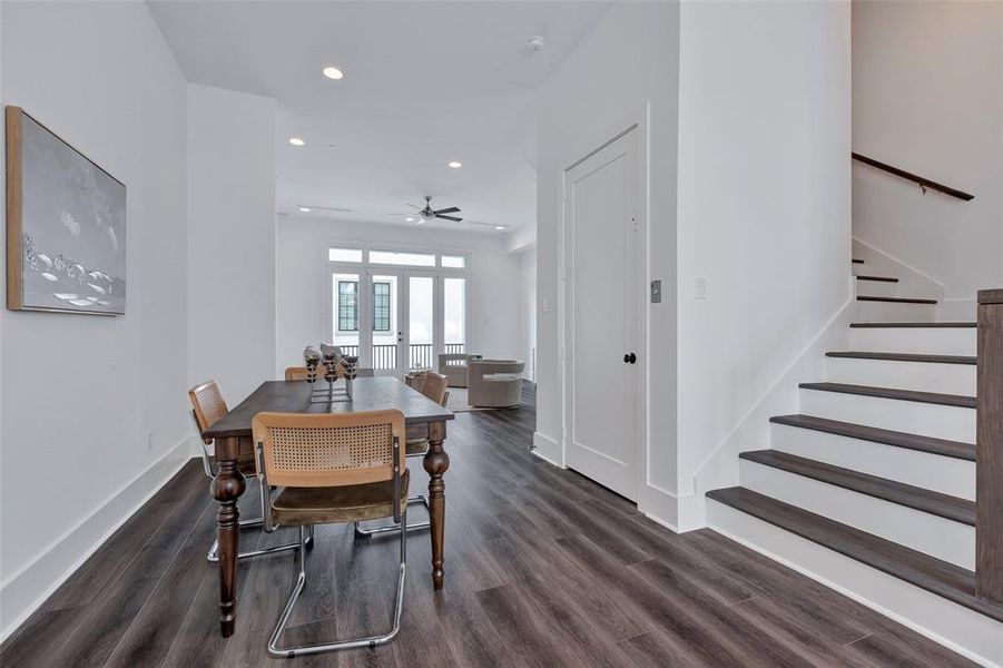 Next to the dining area, you'll find the staircase leading up to the third floor, seamlessly integrating vertical access into the open layout. The closed door is the elevator access on the second floor.