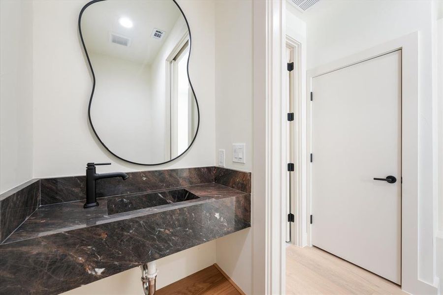 Bathroom featuring hardwood / wood-style flooring and sink