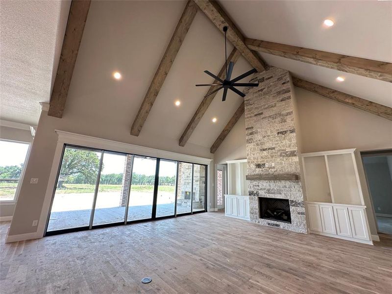 Vaulted ceilings, gorgeous beams and stone fireplace