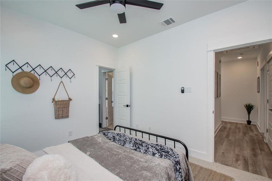 Secondary bedroom with a walk-in closet! Model home photos - FINISHES AND LAYOUT MAY VARY! Ceiling fans are NOT INCLUDED!