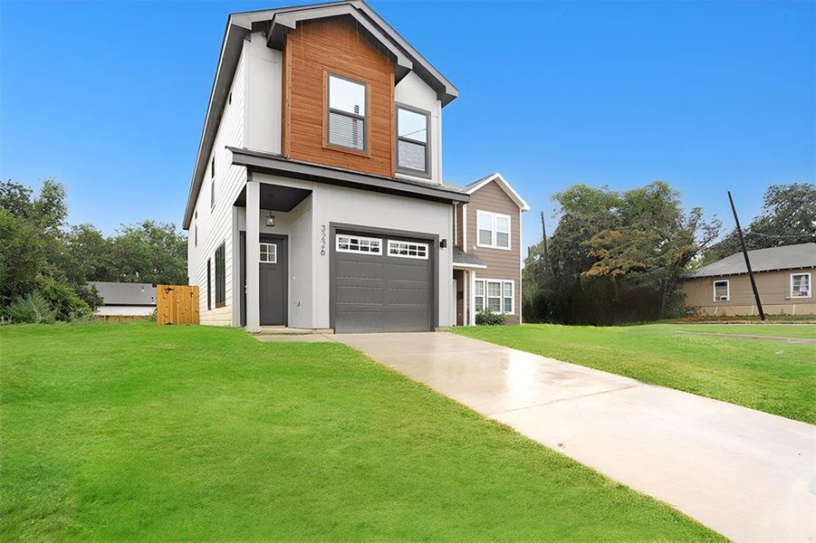 View of front of home featuring a garage and a front yard