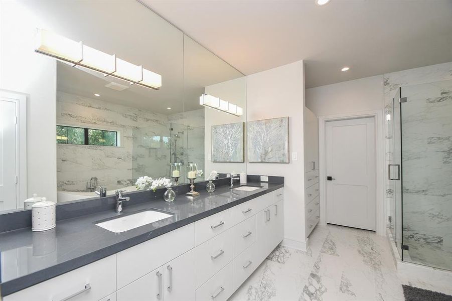 Your primary ensuite bath is warming and inviting with shades of grey and white.