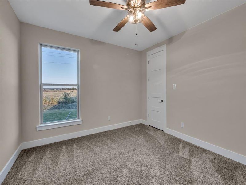 Unfurnished room featuring carpet and ceiling fan