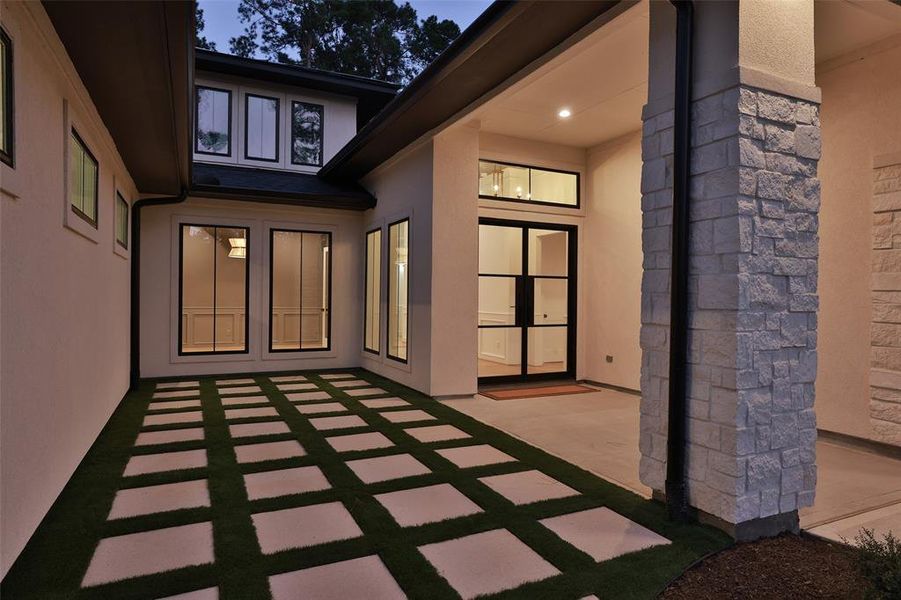 The front courtyard with turf and pavers.