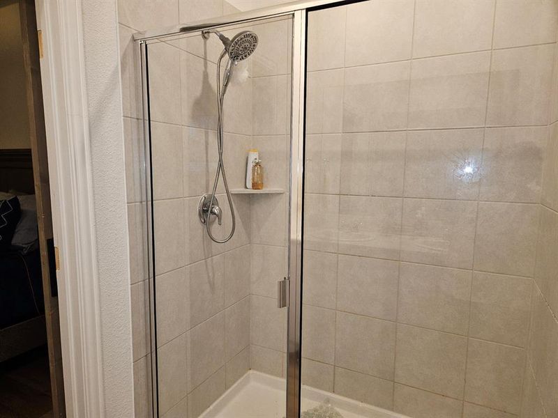 Bathroom featuring a shower with shower door