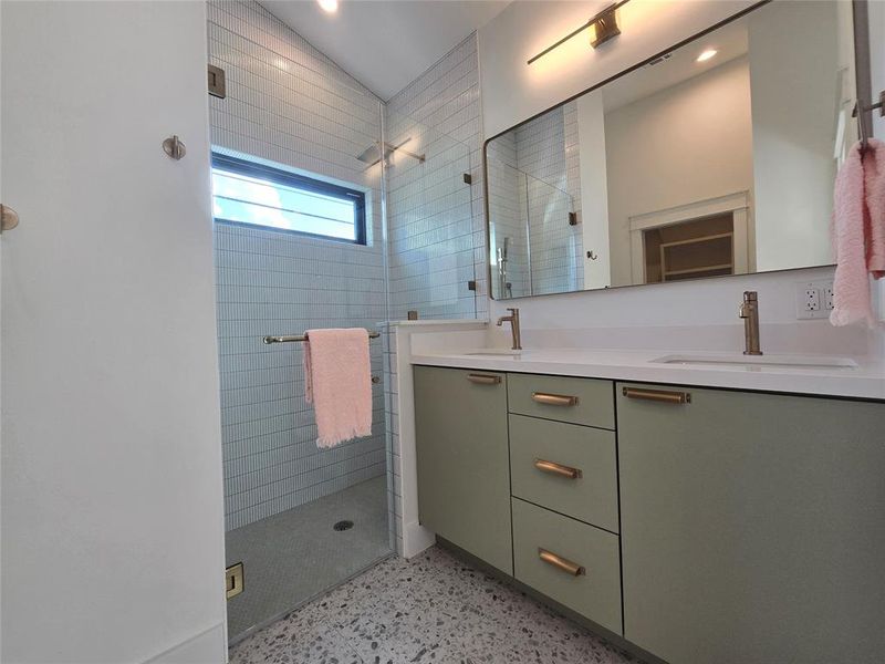 Primary bath with dual vanity and a walk in shower.