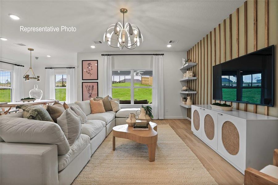 Living room featuring light hardwood / wood-style flooring and an inviting chandelier