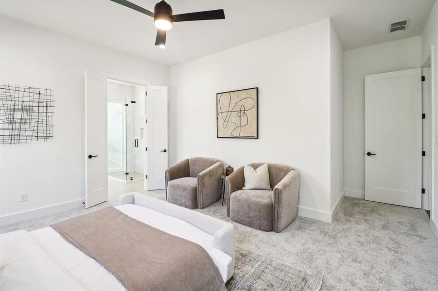 Carpeted bedroom featuring ceiling fan