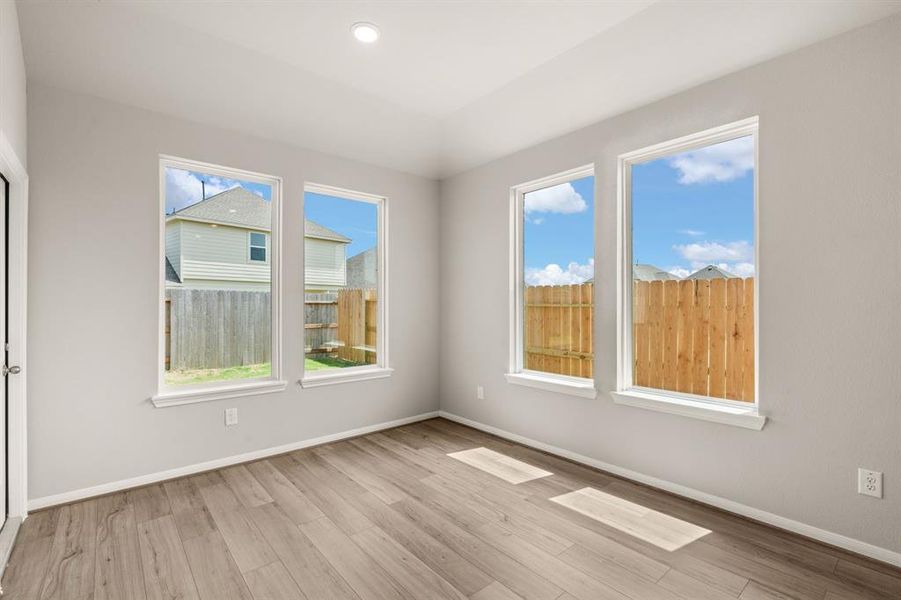 With an abundance of natural light streaming through the windows, the breakfast nook is bathed in a sunny glow, creating the perfect atmosphere to enjoy your morning coffee or a family breakfast.