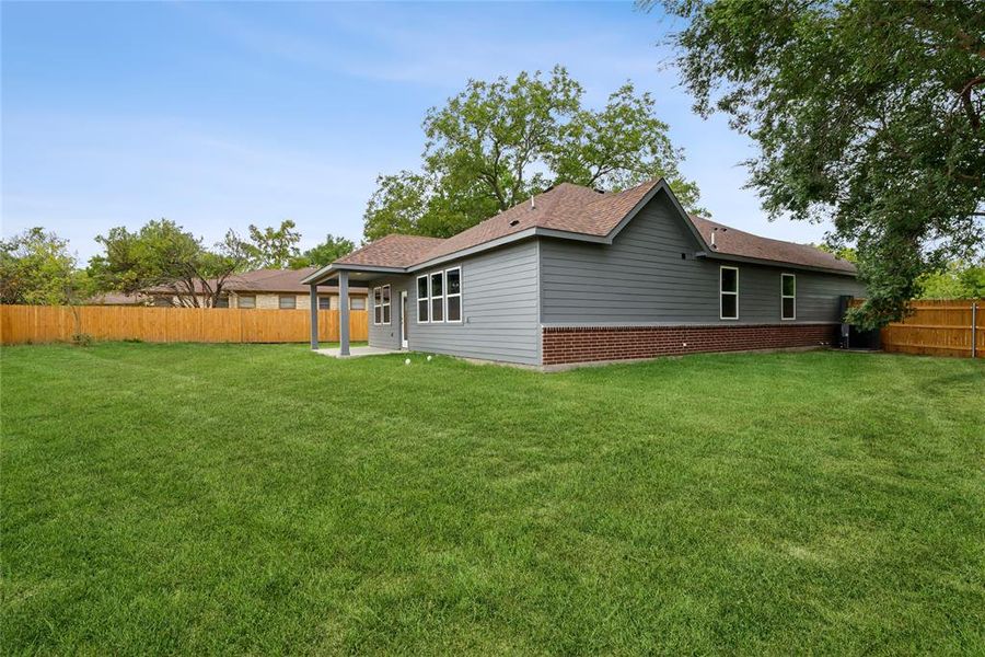 Rear view of property featuring a lawn