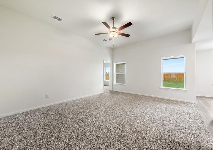 The family room of the Blanco has large windows that let in great natural light and back yard views.