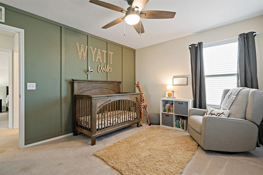 One of 4 bedrooms, this one is located upstairs and features an accent wall and ceiling fan.