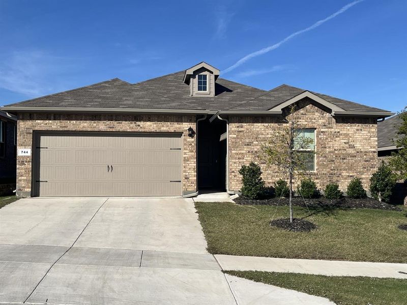 View of front of house with a front lawn and a garage