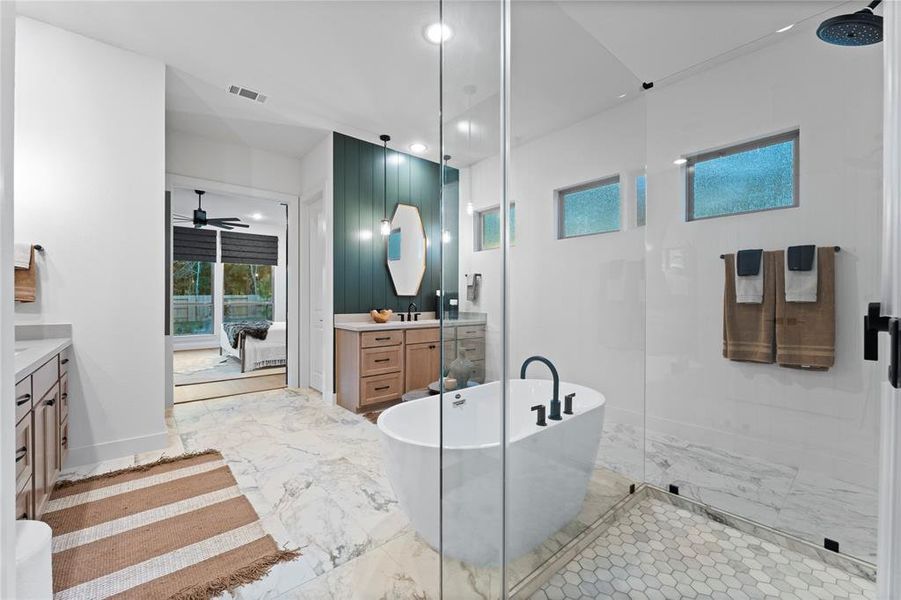 Primary Bathroom with Separate Vanities, Freestanding Tub, and Separate Shower