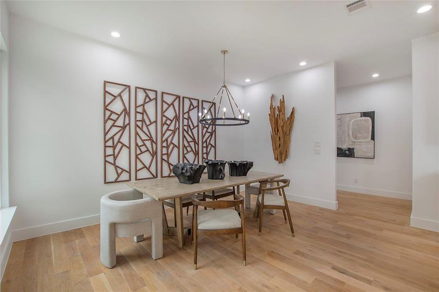 Dining space featuring light hardwood / wood-style flooring and a notable chandelier