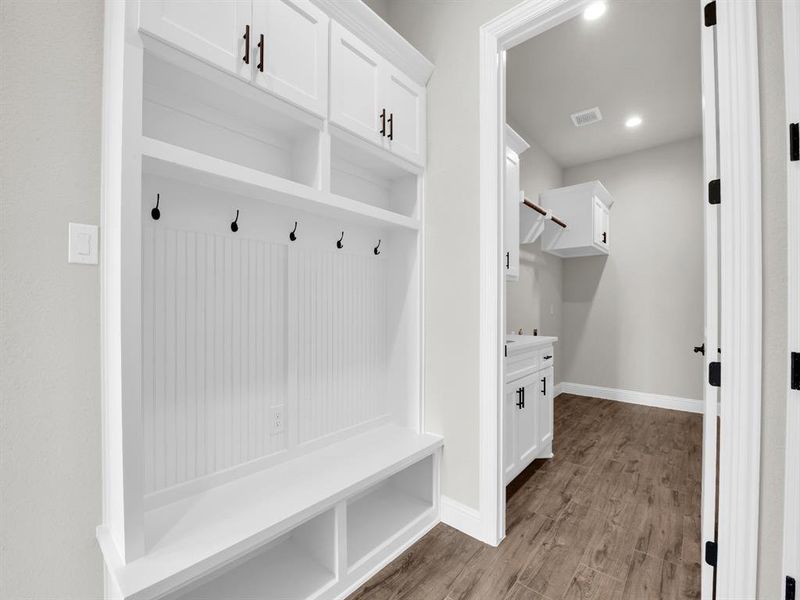 Mudroom with wood-type flooring