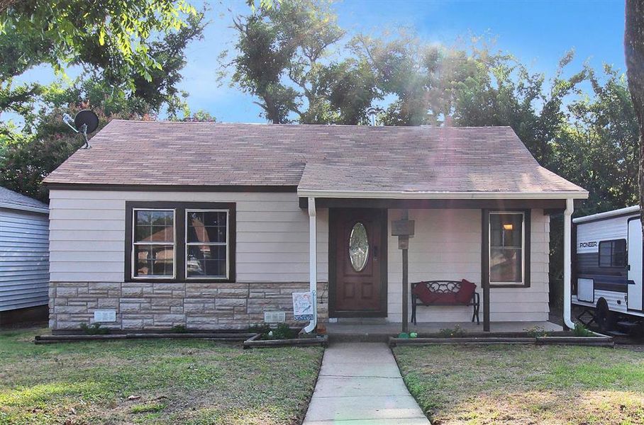 Bungalow-style home with a front yard