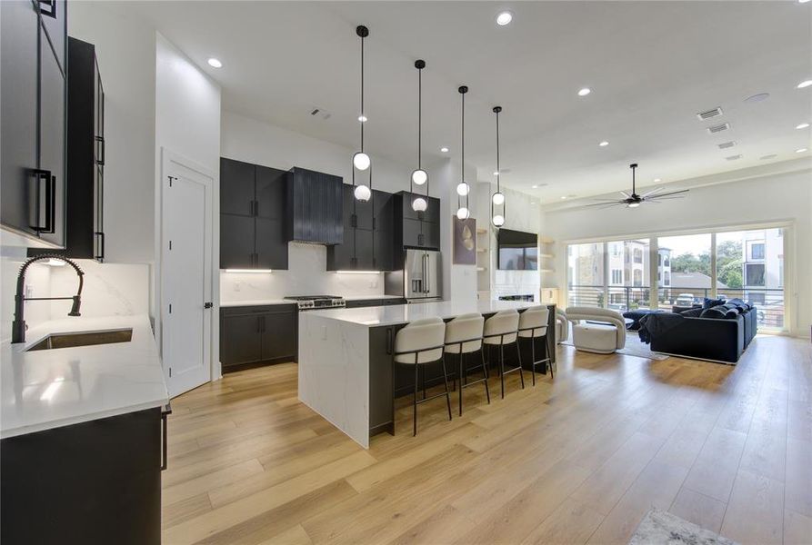 Large open concept with a waterfall quartz countertop