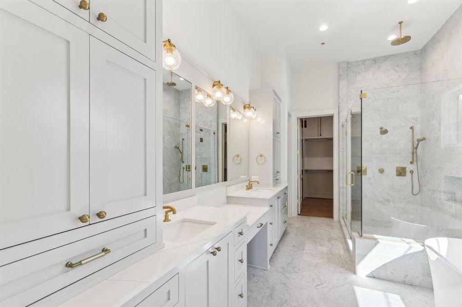 The Primary Bathroom features a knee space for a makeiup station and each vanity has its own storage tower and cabinetry.