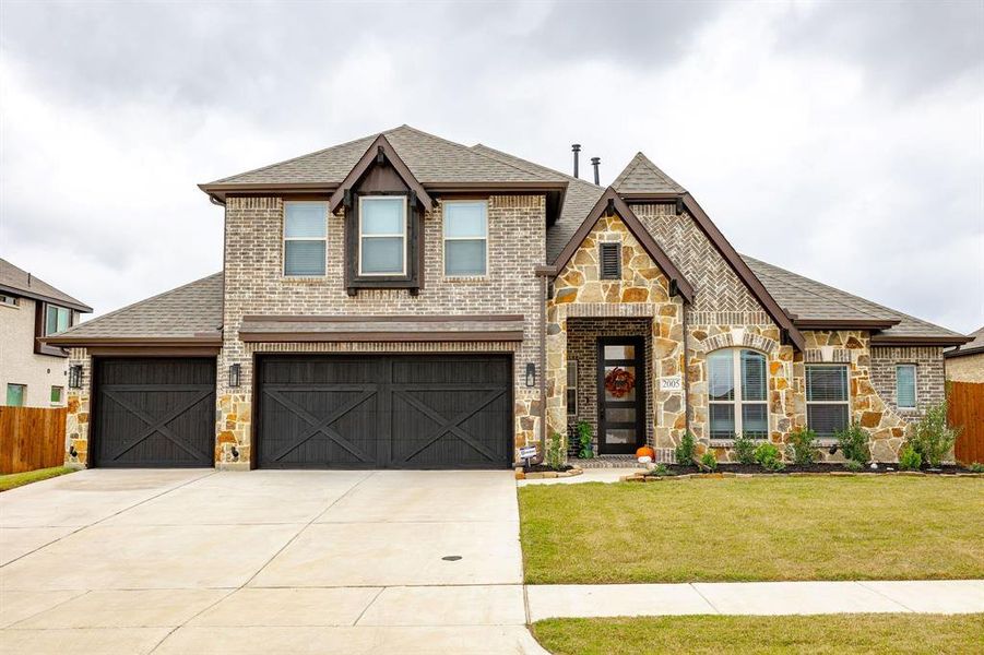 View of front of home with 3 car garage