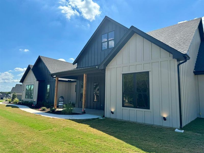 Modern farmhouse style home with a front lawn