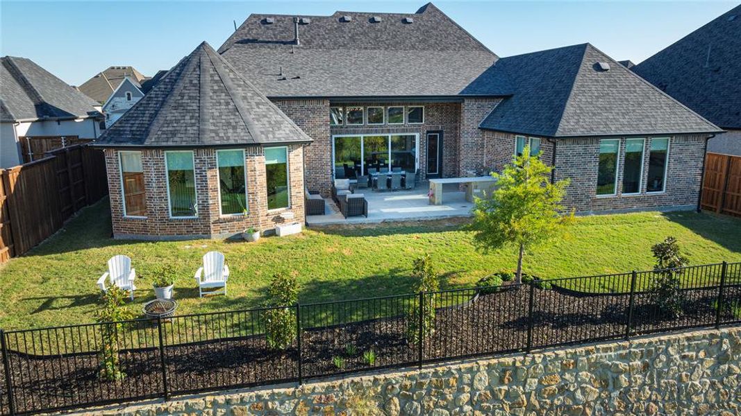 Rear view of property featuring a patio and a yard