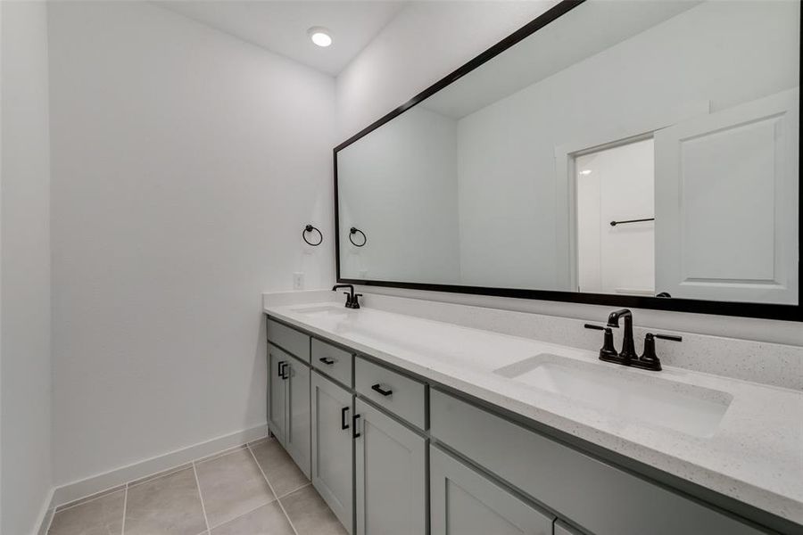 Bathroom featuring double vanity and tile patterned floors