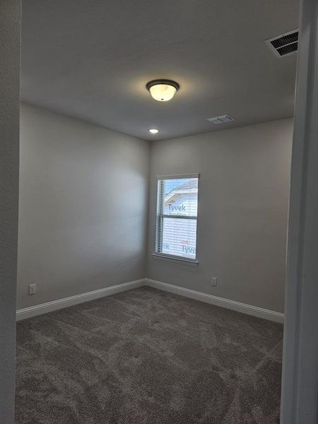 Unfurnished room with dark colored carpet