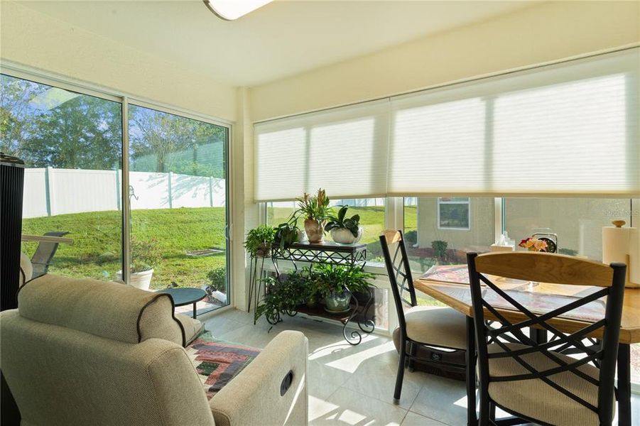 Glass Enclosed Lanai with Light Filtering Blinds.