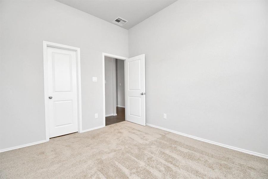 Secondary bedroom at the entrance of the house with large window bring life to the create an inviting living space