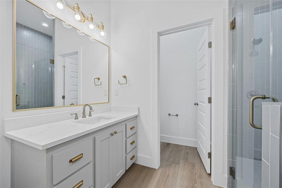 Primary bathroom with dual vanity and soft color palette.