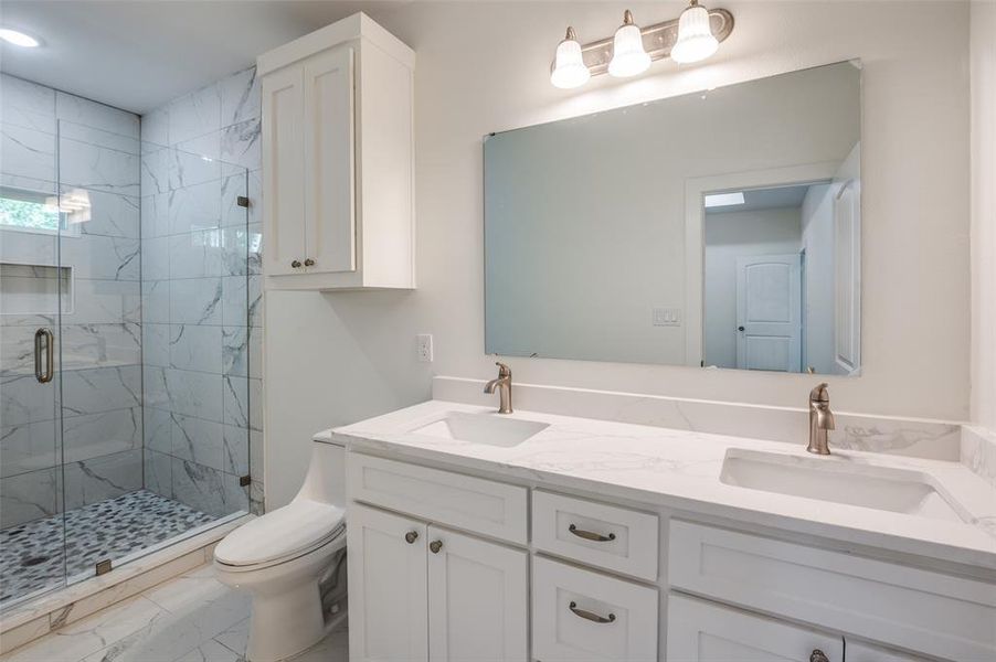 Bathroom with vanity, toilet, and walk in shower