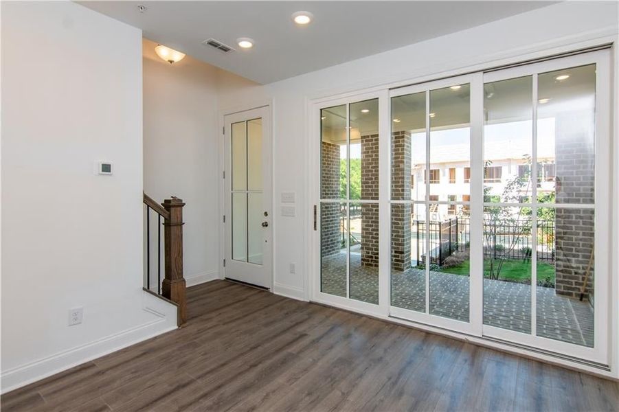 Media / Office room featuring dark wood-type flooring, Front Entry with sliding glass doors , not the actual unit