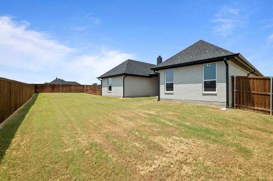 Rear view of house with a yard