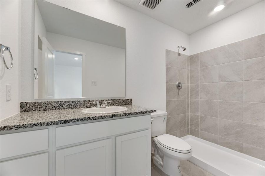 Bathroom with tile patterned floors, toilet, and vanity