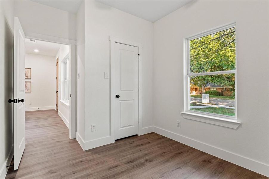 Unfurnished bedroom featuring a closet and light hardwood / wood-style floors