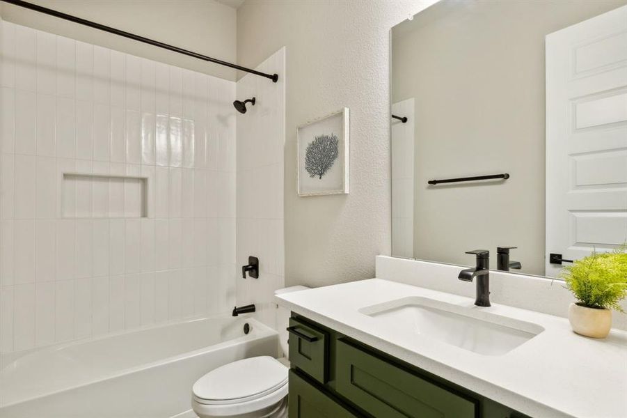 Full bathroom with vanity, toilet, and tiled shower / bath