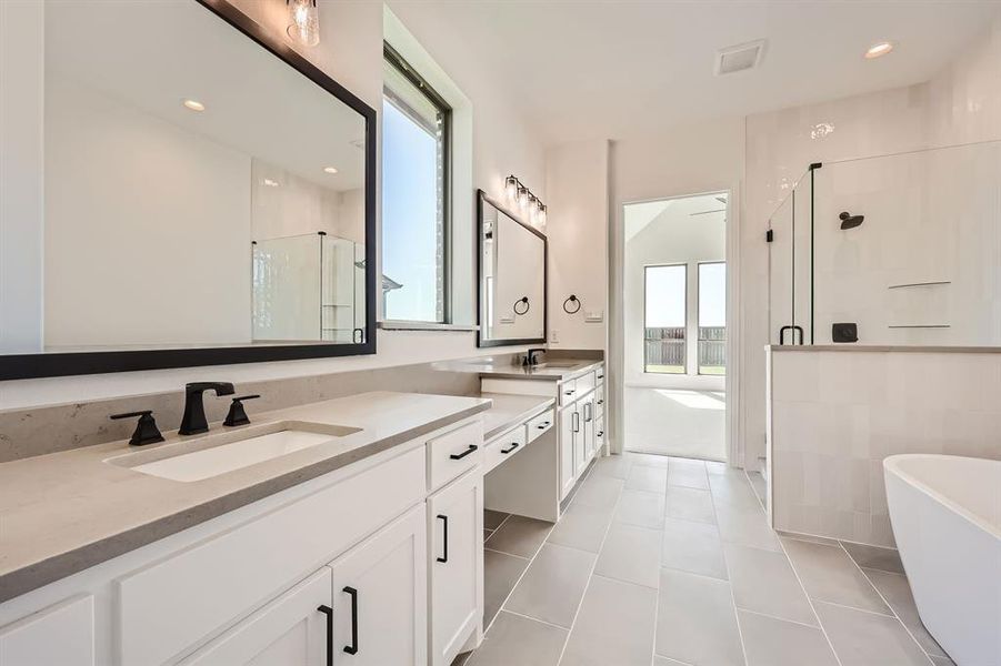 Main bathroom with tile patterned flooring, vanity, and independent shower and bath