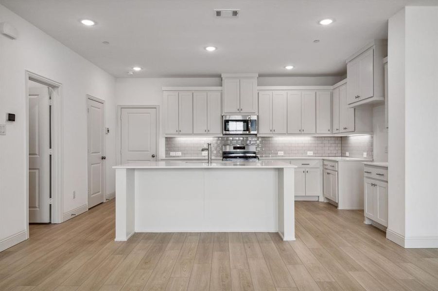 the kitchen island is the hub of this chef's dream kitchen!