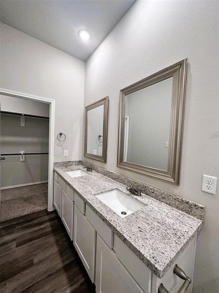 Double sinks, granite counters, framed mirrors- this master bath has it all!